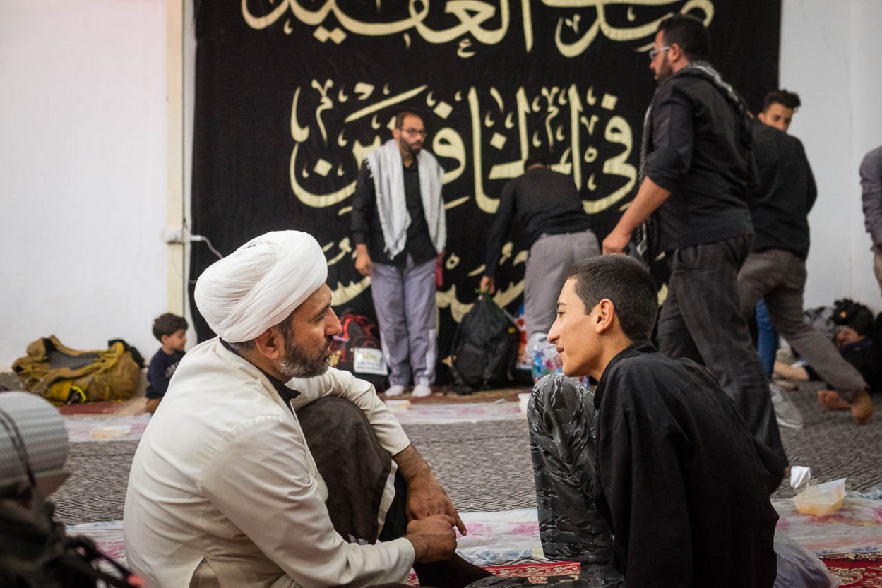 A young man consults and asks a sheikh for an advice in a mawakeb in al-Hilla, close to Karbala, Iraq