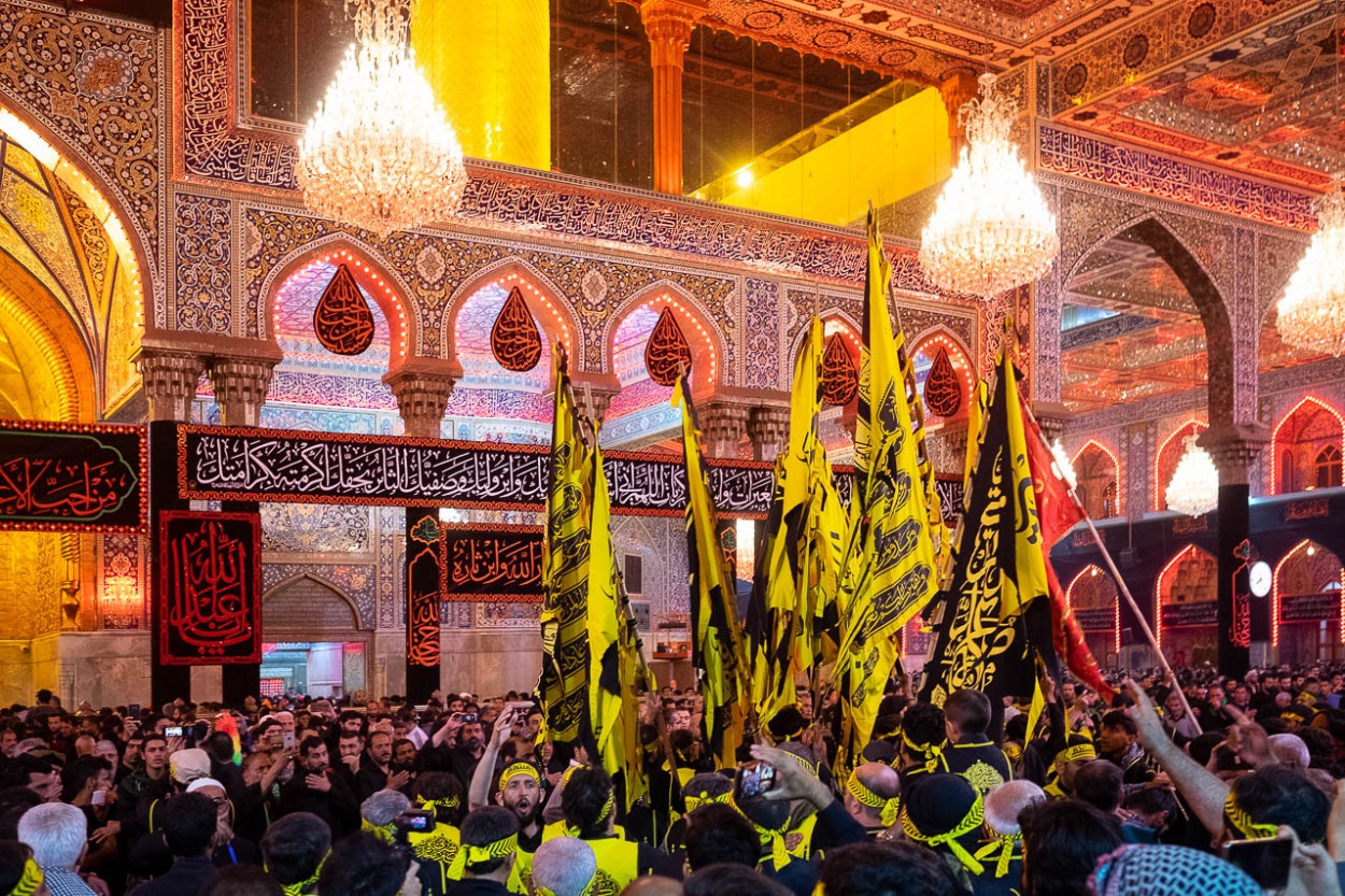 Brothers of Heyat Honar express their devotion inside in the mausoleum of Imam Hussein in Karbala, Iraq